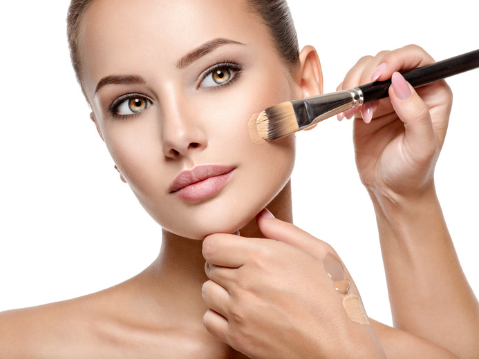 Makeup Artist Applying Liquid Tonal Foundation  on the Face