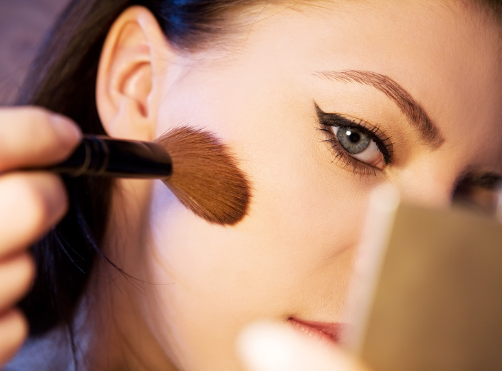  A Woman Using a Makeup Brush