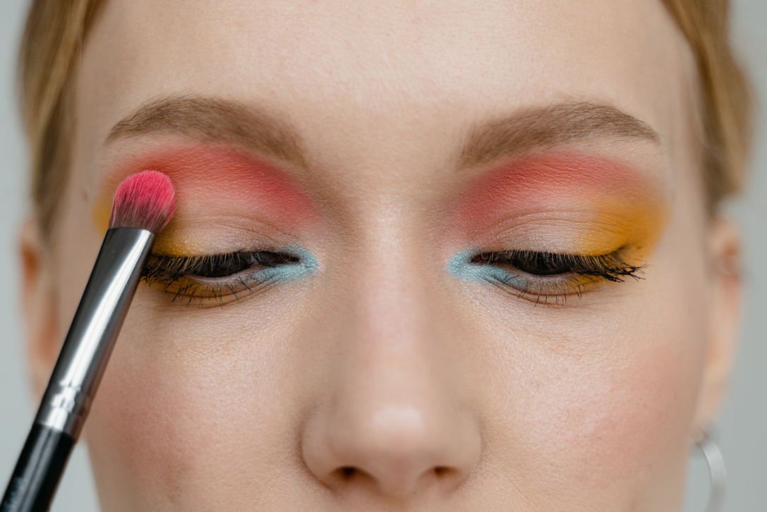 A Woman Applying Pink Eye Shadow