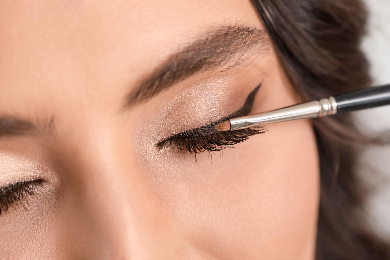 Makeup Artist Putting on Eyeliner